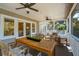 Inviting screened-in porch with comfortable seating and dining area with views of the backyard at 7 Seahorse Ct, Isle of Palms, SC 29451