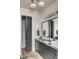 Modern bathroom with a sleek vanity, dark cabinets, marble countertop, and sliding door leading to a closet at 71 Wentworth St # 302, Charleston, SC 29401