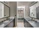 Luxurious bathroom with dual vanities, a glass-enclosed shower, and a soaking tub, creating a spa-like experience at 71 Wentworth St # 302, Charleston, SC 29401