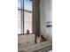 Bright bedroom with a large window, brick view, dresser, decorative art and stylish accessories at 71 Wentworth St # 302, Charleston, SC 29401