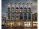 Beautiful white building showcasing multiple arched windows and inviting storefronts with sidewalk at 71 Wentworth St # 302, Charleston, SC 29401