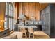 Chef's kitchen featuring wood paneling, stainless steel appliances, island with seating, and a large window at 71 Wentworth St # 302, Charleston, SC 29401