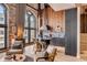 Modern kitchen with custom wood paneling, dark cabinets, large window, and a marble island with seating at 71 Wentworth St # 302, Charleston, SC 29401