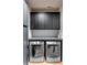 Efficient laundry room with sleek cabinets, modern washer and dryer units, and durable countertops at 71 Wentworth St # 302, Charleston, SC 29401
