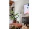 Living room area with plant, modern console table, and sleek wall-mounted TV for stylish, comfortable living at 71 Wentworth St # 302, Charleston, SC 29401