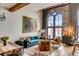 Inviting living area with arched window, comfortable seating, hardwood floors, and stylish artwork at 71 Wentworth St # 302, Charleston, SC 29401
