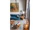 Sunlit living room with blue sofa, area rug, and tall windows at 71 Wentworth St # 302, Charleston, SC 29401