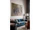 Living area showcasing a tufted blue sofa, patterned rug, and large artwork at 71 Wentworth St # 302, Charleston, SC 29401
