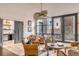 Living room area with comfortable seating around a round table, and a view of the outdoor patio at 71 Wentworth St # 302, Charleston, SC 29401