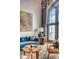 Bright living room featuring a blue velvet sofa, large arched window, and colorful artwork at 71 Wentworth St # 302, Charleston, SC 29401