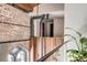 Open loft space highlighting exposed brick, modern piping, and a stylish wooden design at 71 Wentworth St # 302, Charleston, SC 29401