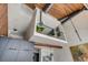 Loft area with glass railing, overlooking an open-concept space featuring wood ceilings and modern lighting at 71 Wentworth St # 302, Charleston, SC 29401