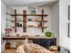 Bright home office with custom shelves, a wooden desk and a neutral chair at 71 Wentworth St # 302, Charleston, SC 29401