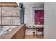 Bright office space with exposed brick, wooden desk, and colorful modern art at 71 Wentworth St # 302, Charleston, SC 29401
