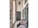 Inviting patio with brick accent wall, stylish chair, and access door at 71 Wentworth St # 302, Charleston, SC 29401