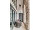 Charming outdoor patio featuring brick accents, stylish seating, and glass windows at 71 Wentworth St # 302, Charleston, SC 29401