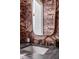 Close-up of powder room vanity, showcasing marble countertop, gold accents, and patterned wallpaper at 71 Wentworth St # 302, Charleston, SC 29401