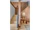 Beautiful staircase showcasing wood treads, a black metal railing, a built-in desk and woven stools against a wood panel wall at 71 Wentworth St # 302, Charleston, SC 29401