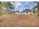 Expansive backyard offers ample space for outdoor activities and gatherings surrounded by mature trees at 7629 Vanderbrook Pl, North Charleston, SC 29420