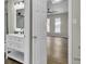 Bathroom view showcasing vanity with sleek faucet, open doorway, and a glimpse into the bedroom at 7629 Vanderbrook Pl, North Charleston, SC 29420