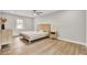 Bright bedroom featuring a ceiling fan, hardwood floors, and natural light from the window at 7629 Vanderbrook Pl, North Charleston, SC 29420