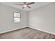 Well-lit bedroom with luxury vinyl plank flooring and a window showcasing the neighborhood at 7629 Vanderbrook Pl, North Charleston, SC 29420