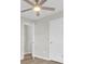 Neutral bedroom with luxury vinyl plank flooring, two doorways, and a ceiling fan at 7629 Vanderbrook Pl, North Charleston, SC 29420
