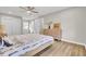 Light-filled bedroom featuring a ceiling fan, wood-look flooring, and fresh white trim throughout at 7629 Vanderbrook Pl, North Charleston, SC 29420