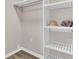 Walk in closet with custom shelving, ample storage space, and modern design at 7629 Vanderbrook Pl, North Charleston, SC 29420
