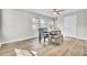 Bright dining room featuring natural lighting, hardwood style floors, and modern ceiling fan at 7629 Vanderbrook Pl, North Charleston, SC 29420