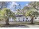 Beautiful single-story home featuring lush palm trees in the front yard, adding a tropical touch at 7629 Vanderbrook Pl, North Charleston, SC 29420