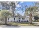 Charming single-story home boasts a manicured lawn and mature trees, creating a welcoming curb appeal at 7629 Vanderbrook Pl, North Charleston, SC 29420