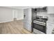 Bright kitchen featuring stainless steel appliances and hardwood style floors at 7629 Vanderbrook Pl, North Charleston, SC 29420