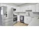 Bright kitchen featuring modern stainless steel appliances, and white cabinets and drawers at 7629 Vanderbrook Pl, North Charleston, SC 29420