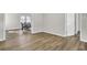 Hardwood flooring and the view of the kitchen from the naturally illuminated living room create an open and airy atmosphere at 7629 Vanderbrook Pl, North Charleston, SC 29420