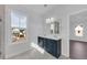 Modern bathroom featuring a double vanity with a navy blue cabinet and a large window with a view of the neighborhood at 782 Blueway Ave, Summerville, SC 29486