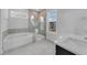 Bright bathroom featuring a soaking tub, glass-enclosed shower, and modern vanity at 782 Blueway Ave, Summerville, SC 29486