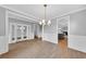 Elegant dining room with paneled walls, hardwood floors, and a stylish chandelier at 782 Blueway Ave, Summerville, SC 29486