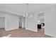 Open dining room with a modern chandelier, light gray walls, and doorway to kitchen at 782 Blueway Ave, Summerville, SC 29486