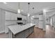 Modern kitchen with white cabinets, quartz countertops, stainless steel appliances, and island at 782 Blueway Ave, Summerville, SC 29486