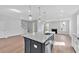 Spacious kitchen island with quartz countertop, stainless steel appliances, and hardwood floors at 782 Blueway Ave, Summerville, SC 29486