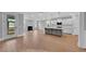 Open-concept living area featuring a fireplace, modern kitchen island, and access to an outdoor patio at 782 Blueway Ave, Summerville, SC 29486