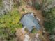 Aerial view of a quaint home surrounded by lush greenery and mature trees, showcasing the property's serene setting at 8262 Fairview Nursery Rd, Hollywood, SC 29449