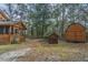 View of the backyard with screened porch and multiple outbuildings at 8262 Fairview Nursery Rd, Hollywood, SC 29449