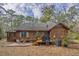 Charming wood cabin with a spacious backyard, deck, and patio area at 8262 Fairview Nursery Rd, Hollywood, SC 29449