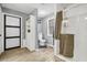 Modern bathroom with white subway tile shower, glass door, and wood-look tile floors at 8262 Fairview Nursery Rd, Hollywood, SC 29449