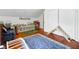 Bright bedroom with hardwood floors, stylish blue rug, wooden climbing toy, and ample storage at 8262 Fairview Nursery Rd, Hollywood, SC 29449