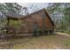 Side exterior of a wood-sided home, featuring neat landscaping and a peaceful setting at 8262 Fairview Nursery Rd, Hollywood, SC 29449