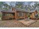 Back exterior view of home with screened porch, patio, and mature trees at 8262 Fairview Nursery Rd, Hollywood, SC 29449