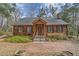 Inviting front exterior of a log cabin with brick walkway and front porch at 8262 Fairview Nursery Rd, Hollywood, SC 29449